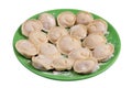 Homemade raw dumplings with pork meat on a green plate isolated Royalty Free Stock Photo