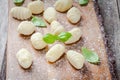Homemade raw gnocchi with flour and fresh basil closeup Royalty Free Stock Photo