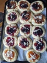 Homemade raw Kolachi pastry with jam and cream cheese filling proofing on a baking pan