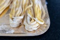 homemade raw uncooked pasta fettuccine, tagliatelle, spaghetti on working table. Raw fresh handmade pasta, italian food at home