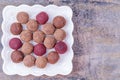 Homemade Raw Vegan Cacao Energy Balls on White Plate on Gray Marble Background Royalty Free Stock Photo