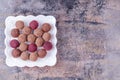 Homemade Raw Vegan Cacao Energy Balls on White Plate on Gray Marble Background Royalty Free Stock Photo