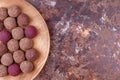 Homemade Raw Vegan Cacao Energy Balls on Wooden Plate on Brown Marble Background Royalty Free Stock Photo