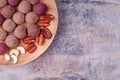 Homemade Raw Vegan Cacao Energy Balls on Wooden Plate on Gray Marble Background Royalty Free Stock Photo