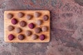 Homemade Raw Vegan Cacao Energy Balls on Wooden Tray on Brown Marble Background Royalty Free Stock Photo