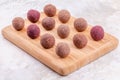Homemade Raw Vegan Cacao Energy Balls on Wooden Tray on White Marble Background Royalty Free Stock Photo