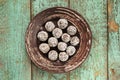 Homemade raw vegan sweets in coconut shavings in ceramic plate o