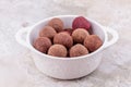 Homemade Raw Vegetarian Cacao Energy Balls in White Bowl on Marble Background Royalty Free Stock Photo