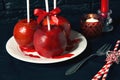 Homemade red caramel coating apples on a sticks for Christmas and New Year