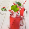 Homemade red currant lemonade in a mason jar with decor of berry on ligth wooden table. Royalty Free Stock Photo