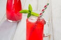 Homemade red currant lemonade in a mason jar with decor on ligth wooden table. Royalty Free Stock Photo