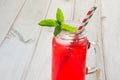 Homemade red currant lemonade in a mason jar with decor on ligth wooden table. Royalty Free Stock Photo