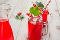 Homemade red currant lemonade in a mason jar and garnish of berry branch on ligth wooden table. Royalty Free Stock Photo