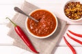 Homemade red Harissa Paste, chili pepper spices and fresh red chilli peppers Royalty Free Stock Photo