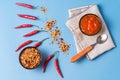 Homemade red Harissa Paste, chili pepper spices and fresh red chilli peppers Royalty Free Stock Photo