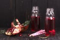 Homemade red pomegranate lemonade in small glass bottles