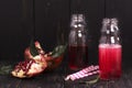 Homemade red pomegranate lemonade in small glass bottles