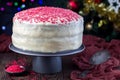 Homemade red velvet cake with cream cheese frosting and red sugar decoration, low key photo with boke lights and christmas Royalty Free Stock Photo