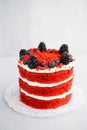 Homemade red velvet cake decorated with berries on a light wooden background Royalty Free Stock Photo