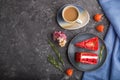 Homemade red velvet cake with milk cream and strawberry  with cup of coffee on a black concrete background. top view, copy space Royalty Free Stock Photo