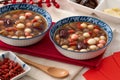 Homemade red and white tangyuan with syrup soup, dried longan pulp, red dates for Winter solstice Royalty Free Stock Photo