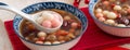 Homemade red and white tangyuan with syrup soup, dried longan pulp, red dates for Winter solstice Royalty Free Stock Photo