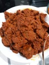 Homemade rendang on a plate. Rendang is indonesian traditional food, made from beef, coconut milk, spices and herbs Royalty Free Stock Photo