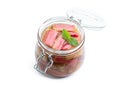 Homemade rhubarb jam in jar with raw stalk rhubarb isolated on white Royalty Free Stock Photo