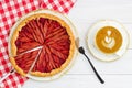 Homemade rhubarb and strawberry pie and cup of coffee on white wooden table Royalty Free Stock Photo