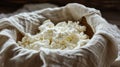 Homemade ricotta cheese draining in a colander with cheesecloth on a wooden table. Ai Generative