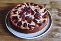 Homemade Ricotta Plum Cake on wooden table. Cottage cheese casserole with vanilla, semolina and plums