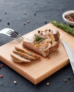 Homemade roasted pork meat on cutting board with cutlery, herbs and spices. Royalty Free Stock Photo