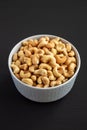 Homemade Roasted and Salted Cashews in a Bowl on a black background, side view Royalty Free Stock Photo