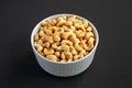 Homemade Roasted and Salted Cashews in a Bowl, side view Royalty Free Stock Photo