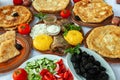 Homemade Romanian Food with grilled fish, polenta, pies, vegetables with red wine