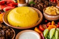 Homemade Romanian Food with polenta, meat, cheese and vegetables. Delicious corn porridge in clay dishes.