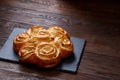 Homemade rose buns on wooden cutting board over rustic vintage background, close-up, shallow depth of field Royalty Free Stock Photo