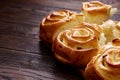 Homemade rose buns on wooden cutting board over rustic vintage background, close-up, shallow depth of field Royalty Free Stock Photo