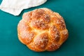 Homemade round challah with sesame seeds. Traditional jewish pastry