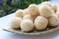 Homemade round coconut pralines covered in coconut flakes