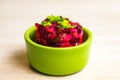 Homemade Russian beet salad vinegret in green bowl on white table background Royalty Free Stock Photo