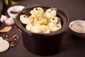 Homemade russian pelmeni meat dumplings italian ravioli in the small black pan Royalty Free Stock Photo