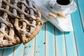 Homemade rustic apple tart pie on dish over wooden turquoise background