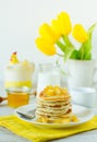 Homemade rustic pancakes stack with baked apples and walnuts