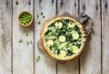 Homemade rustic vegetable pie quiche with spinach, zucchini and green peas