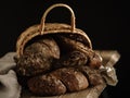Homemade rye bread in a basket on a dark background. Royalty Free Stock Photo