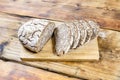 Homemade rye bread with sunflower and pumpkin seeds on wooden background. Side view. Royalty Free Stock Photo