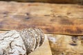 Homemade rye bread with sunflower and pumpkin seeds on wooden background. Left on photo. Royalty Free Stock Photo