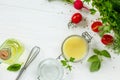 Homemade salad dressing vinaigrette with mustard and olive oil on a white kitchen wooden table. Royalty Free Stock Photo