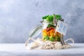 Homemade salad in glass jar with quinoa and vegetables with label lunch time no plastic and take